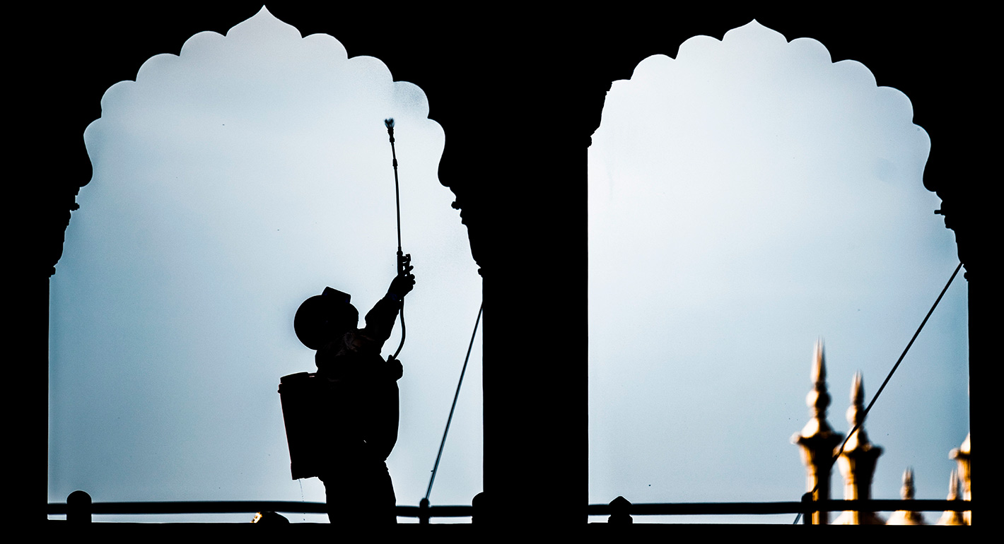 A worker cleans a mosque
