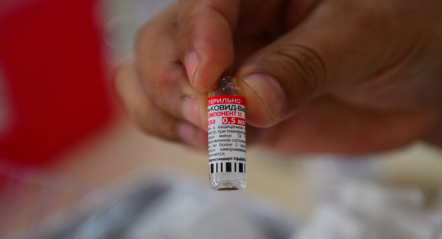 A health worker shows a dose of the second component of the Sputnik V vaccine against COVID-19