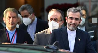 Iran chief nuclear negotiator exiting a building